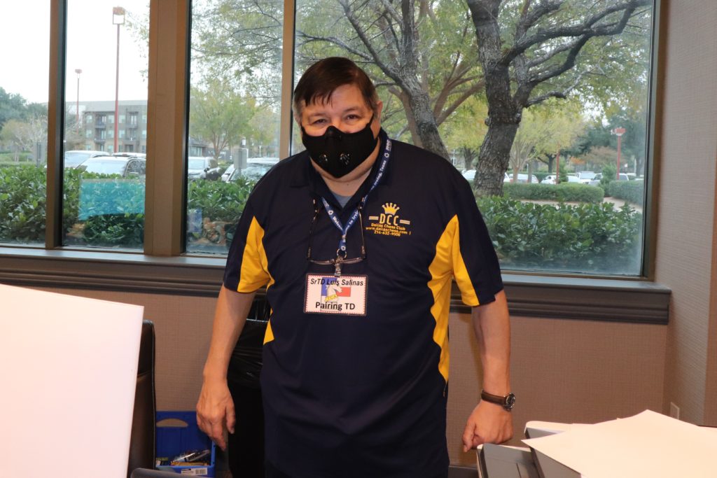 Senior Tournament Director Luis Salinas, surrounded by chess computer pairing equipment at the 2020 Texas State and Amateur Championship.